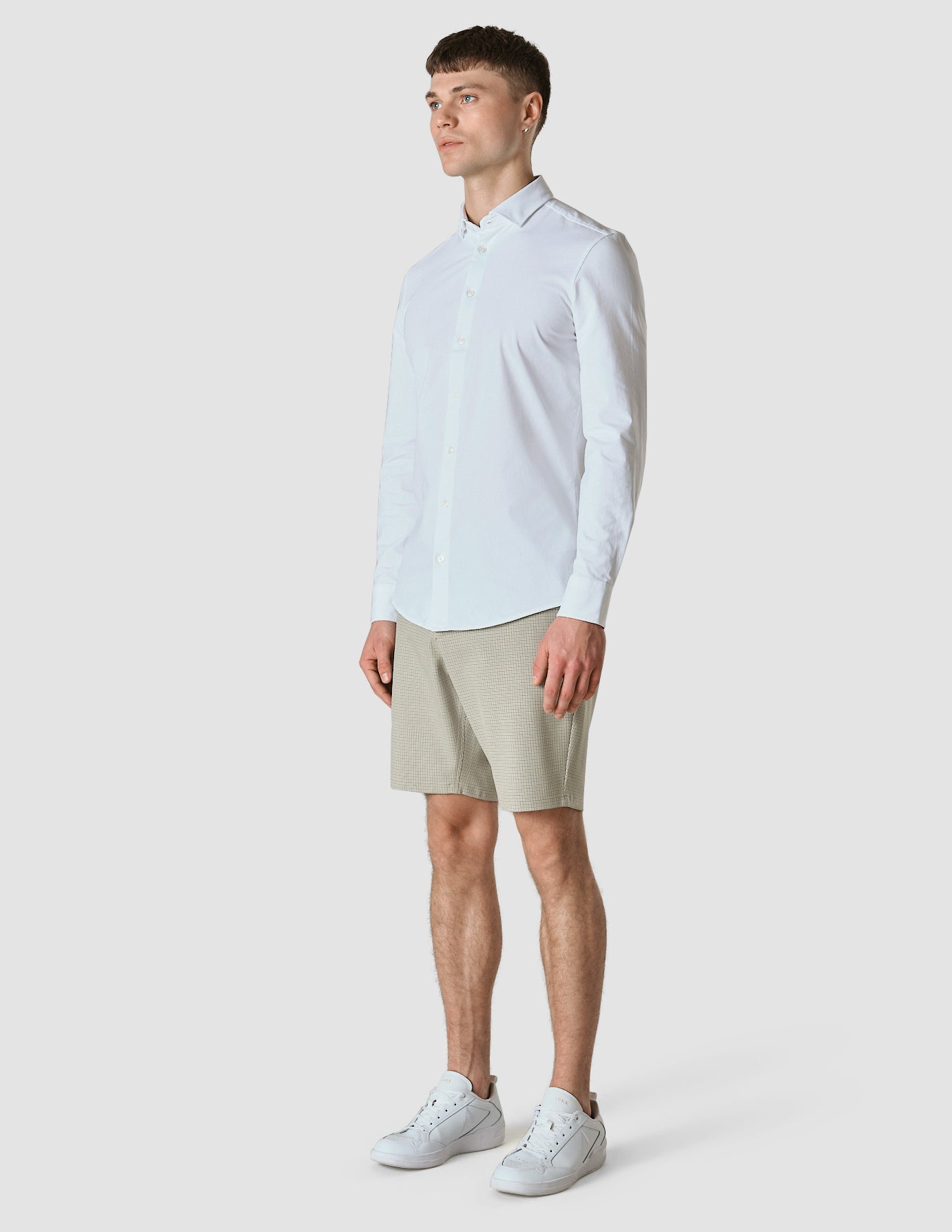 Model in full body wearing Essential Shorts Duo Check green shorts with a white shirt